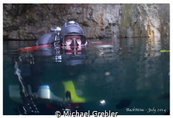 Cave diver at the surface of a flooded mine, near Bucking... by Michael Grebler 